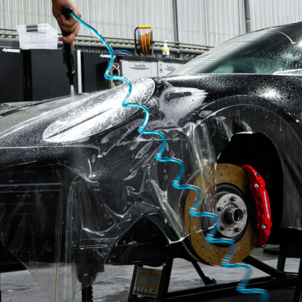 On this 911 Turbo we wrapped the film into the headlight housing, the side reflector housing, and into the wheel well.